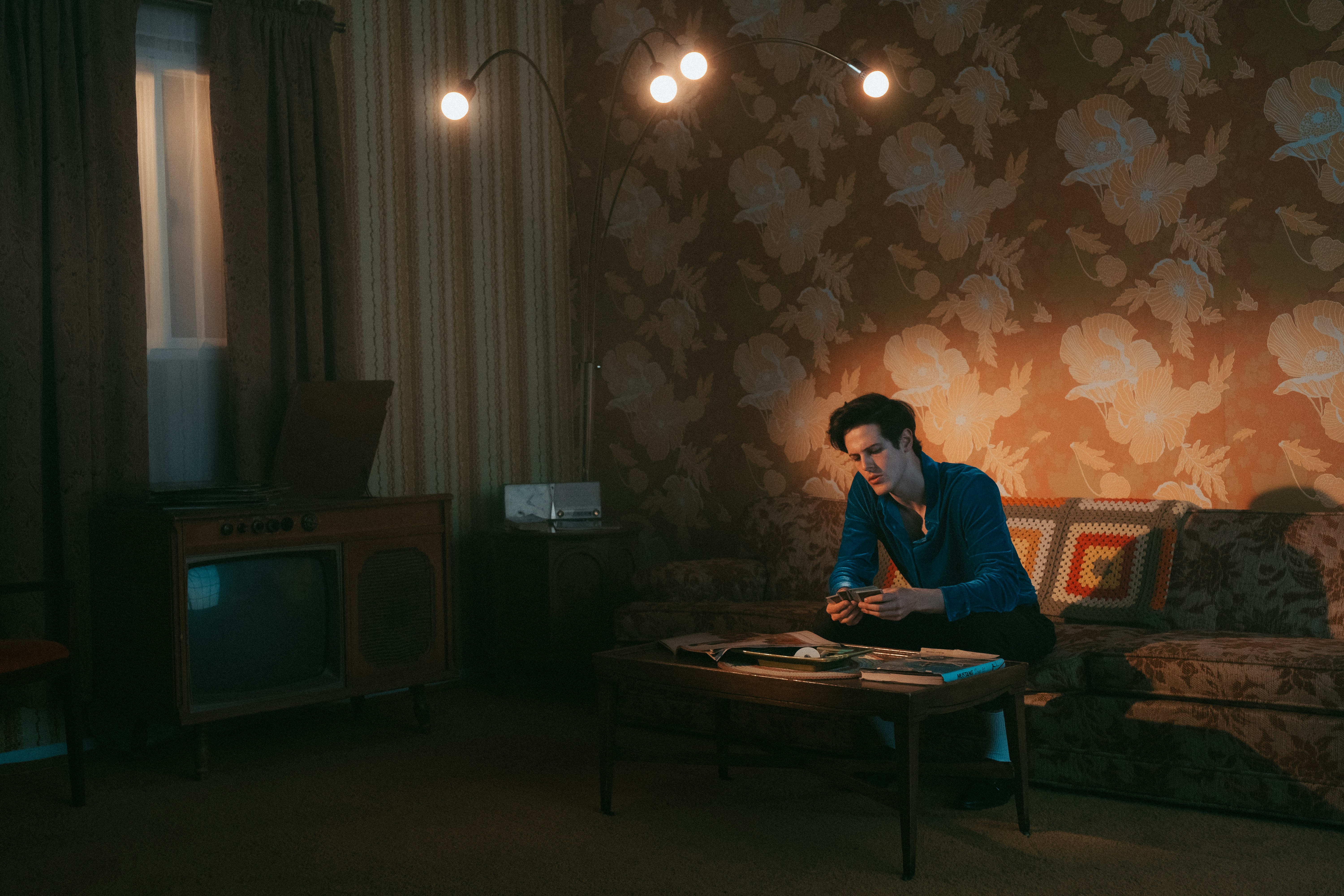 man in blue dress shirt sitting on chair